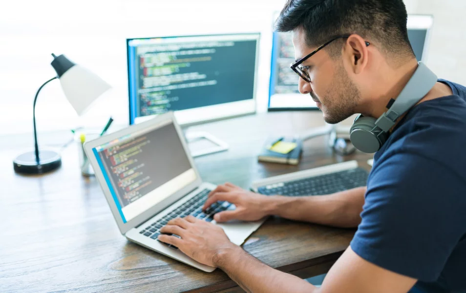 Male IT tester working on his laptop
