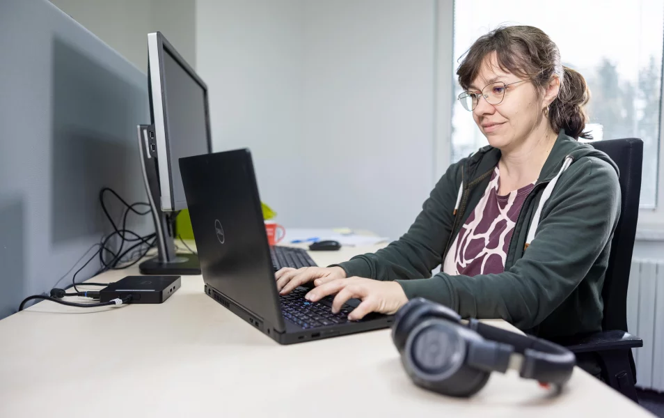 IT Business Consultant writes on a laptop in the office