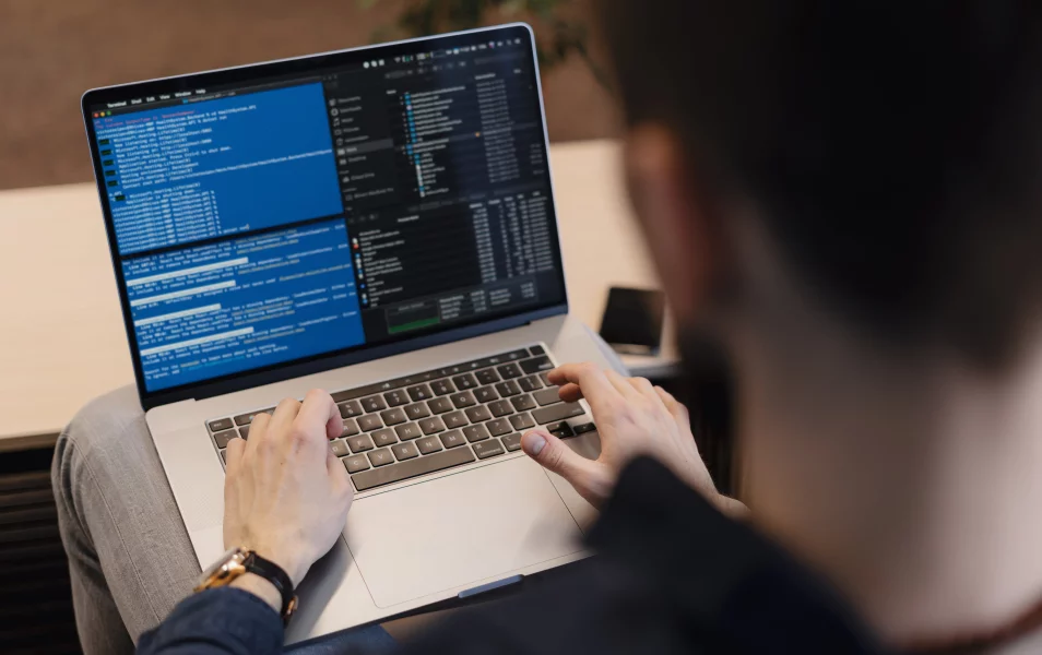 A male IT tester reviews the source code of a program